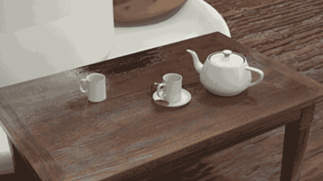 Mesa de té con tetera, platillo, taza y jarra de leche.